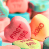 candy hearts, the focus is on two hearts reading 'first kiss' and 'XOXO'